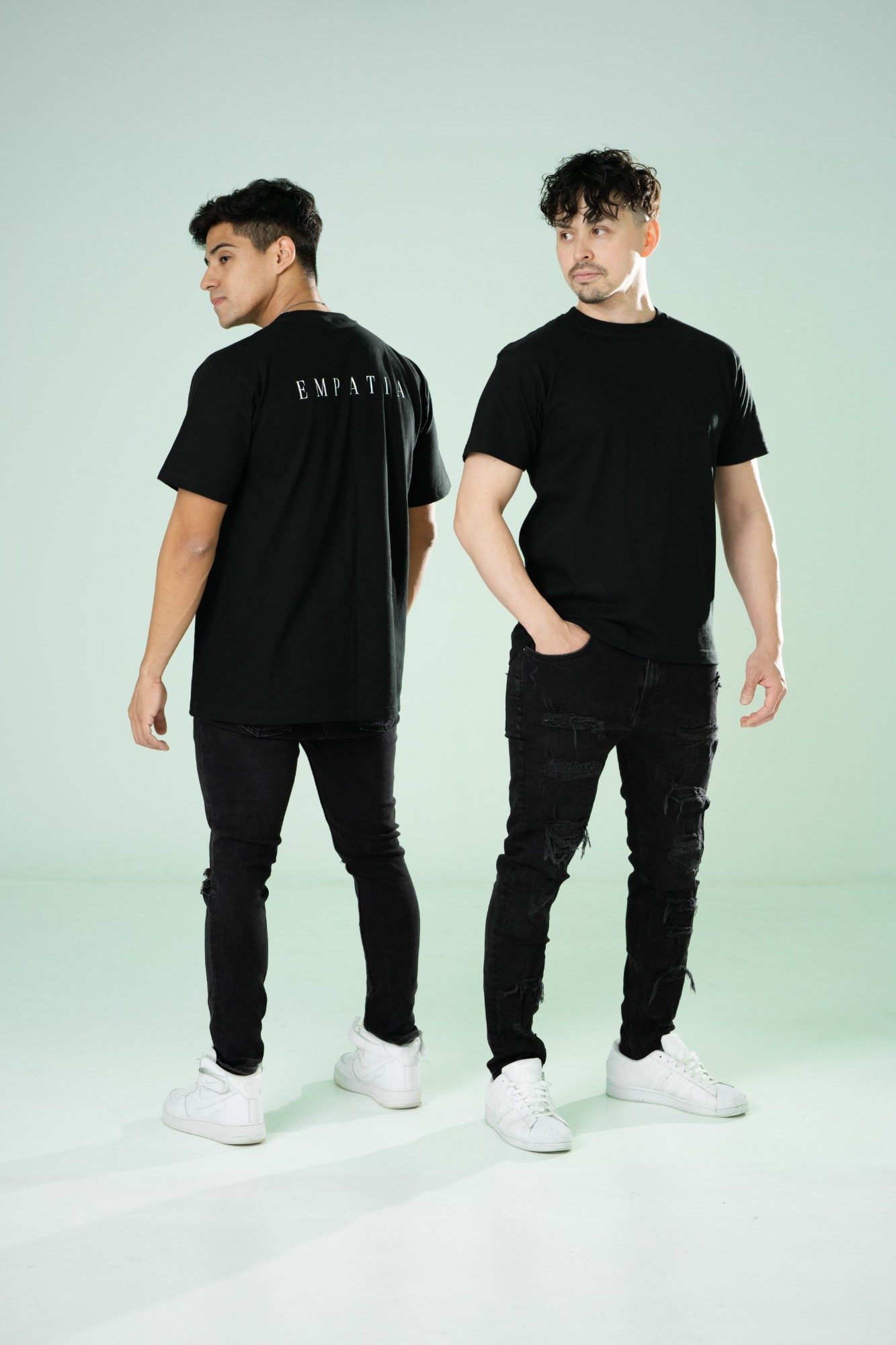 EMPATIA の黒いTシャツを着た二人のモデル(背中に EMPATIA のロゴ)